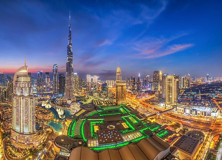 A nighttime view of Dubai's dazzling skyline, illuminated with twinkling city lights. 