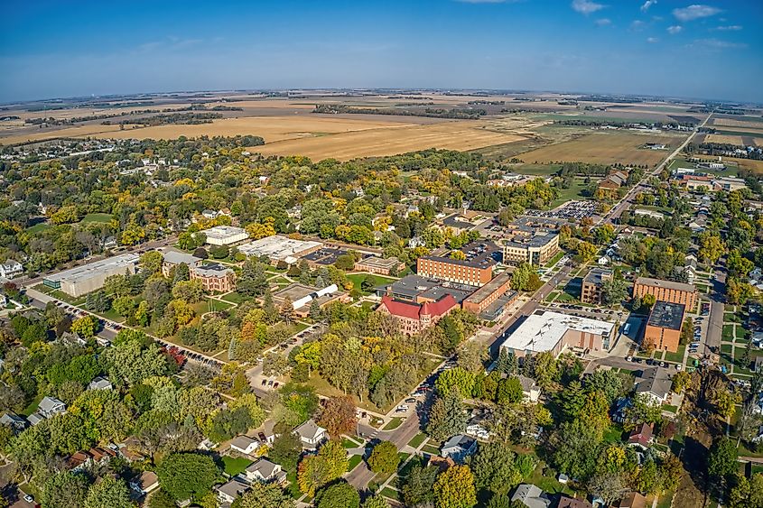 Aerial view of a public state university in Madison, South Dakota, showcasing the campus buildings, green spaces, and surrounding area.