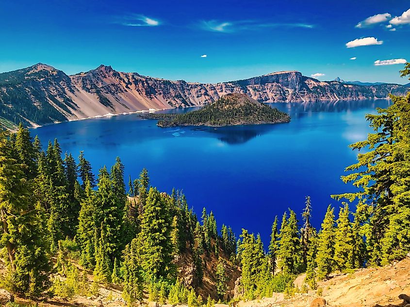 Wizard Island rises from the deep blue waters of Crater Lake in Crater Lake National Park, Oregon.