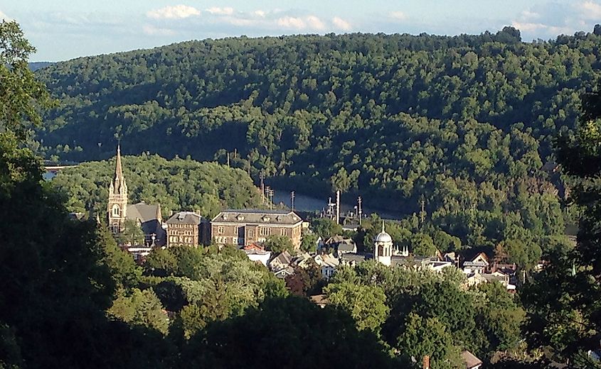 The small town of Little Falls, New York is seen from a high point over its steeples and the Erie Canal.