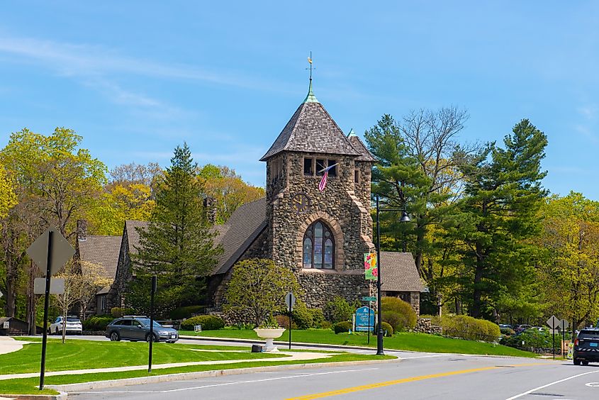 First Parish Church at 349 Boston Post Road in the historic town center of Weston, Massachusetts, surrounded by spring blooms.