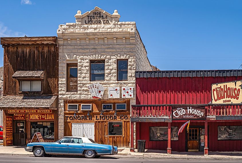 Three historic buildings holding iconic businesses against blue sky in Tonopah, Nevada. Editorial credit: Claudine Van Massenhove / Shutterstock.com