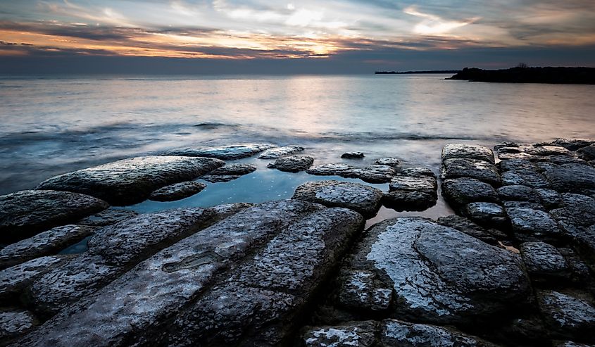 Rocks on the shoreline of Lake Ontario during sunset near Cobourg, Ontario