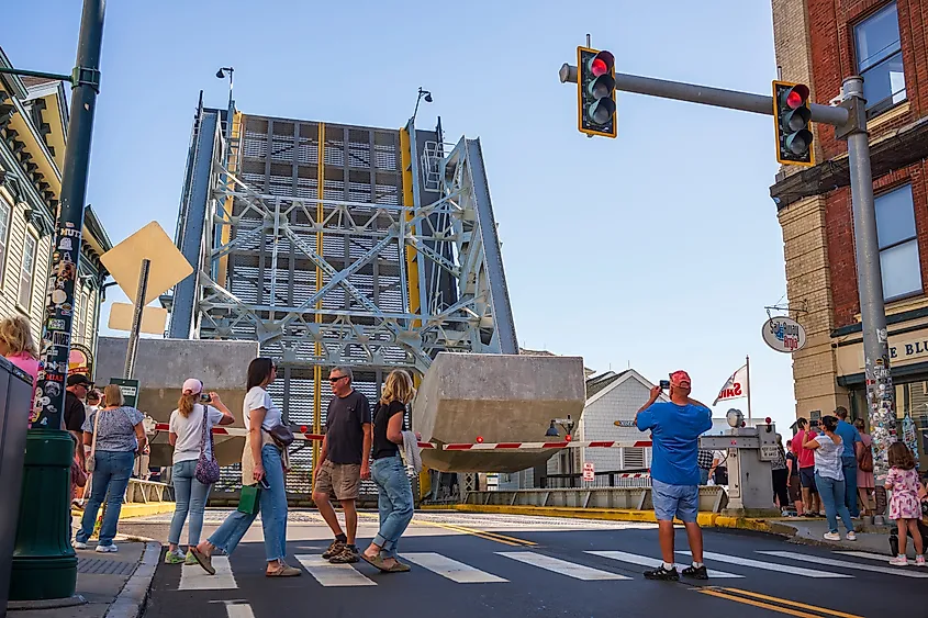 Tourists watch the rising of the Mystic River Bascule Bridge in Mystic, Connecticut.
