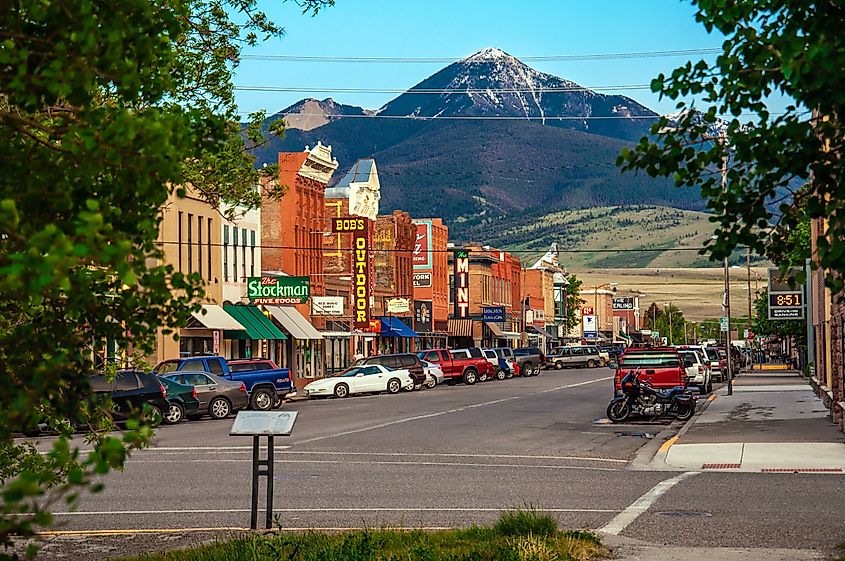 Historic center of Livingston, Montana, near Yellowstone National Park, with snow-capped hills in the background during summer.