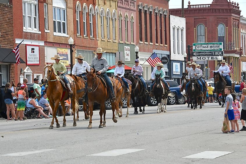 Members of the local 4-H club ride their horses down Main Street in Council Grove, Kansas