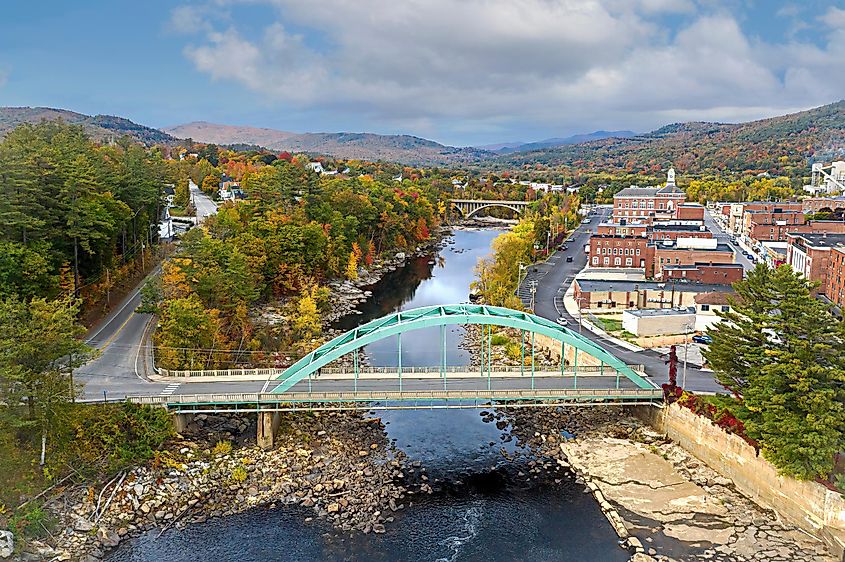 Aerial view of buildings, a bridge, and forests in and around Rumford, Maine.