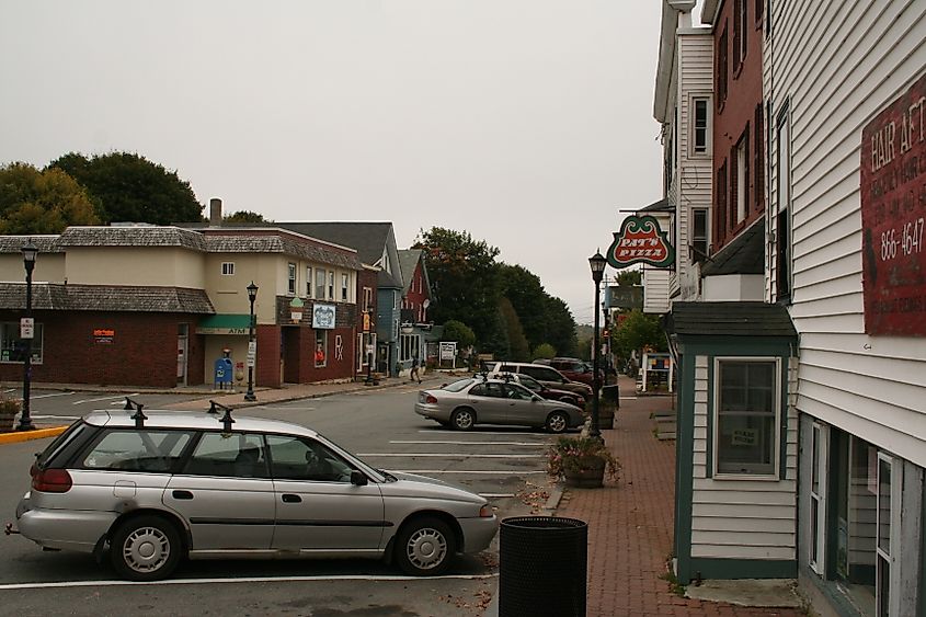 Mill Street in Orono, Maine, a quiet street lined with a mix of local businesses and historic buildings, reflecting the small-town atmosphere.