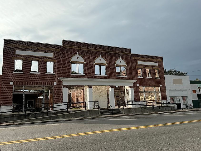 Old brick building in downtown Geneva County, Alabama, under a cloudy sky.