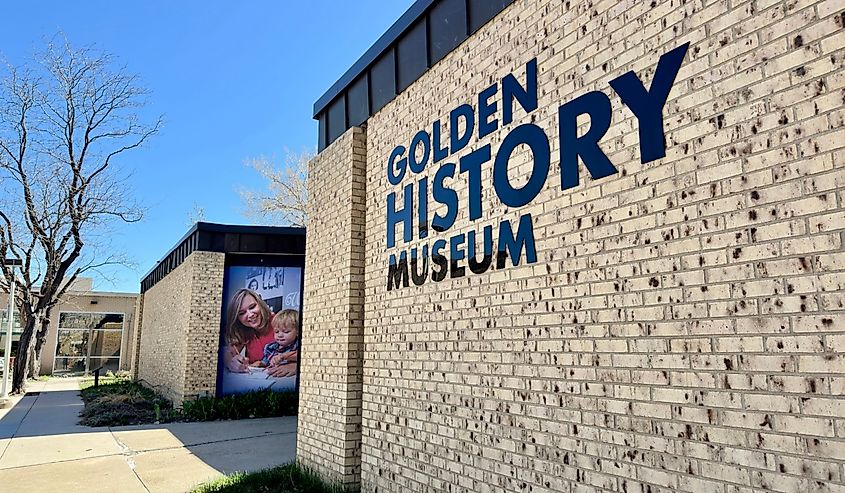  Exterior of Golden History Museum with sign on textured, brick wall. Outside view on a spring day.