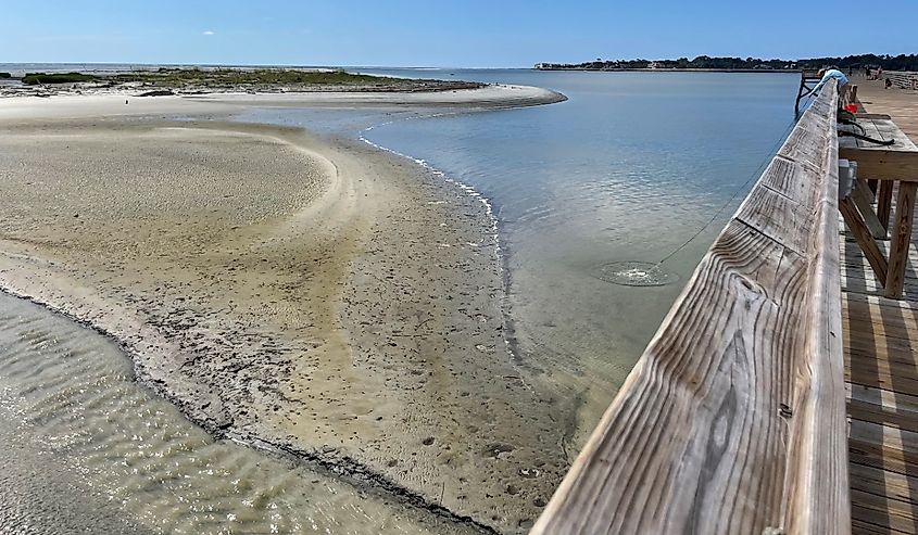 Waterfront view from fishing pier at Hunting Island State Park in Beaufort County, South Carolina. Semitropical barrier island. Boneyard Beach, lagoon, fishing, nature trails, habitats, and birding. 