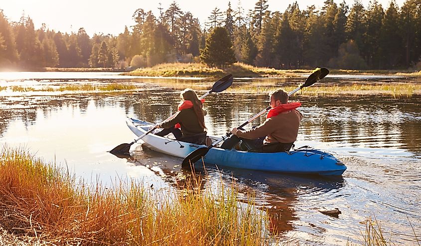 Couple kayaking on lake, back view, Big Bear, California.