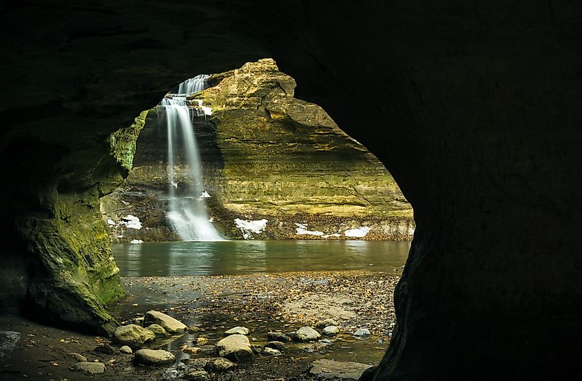 View through the cave to a Winter cascade in the Lower Dells. Matthiessen State Park, Illinois