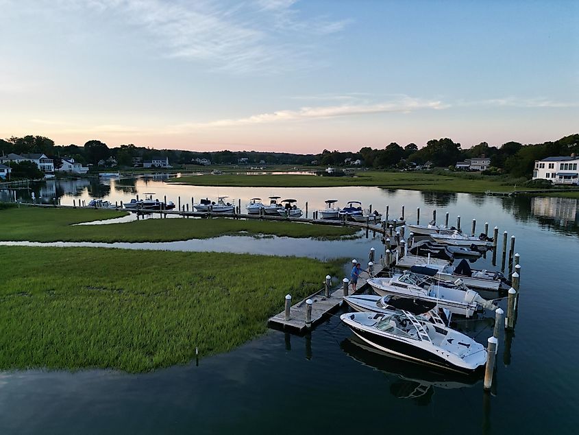 Port with boats and houses on the coast during sunset, Old Saybrook, CT.