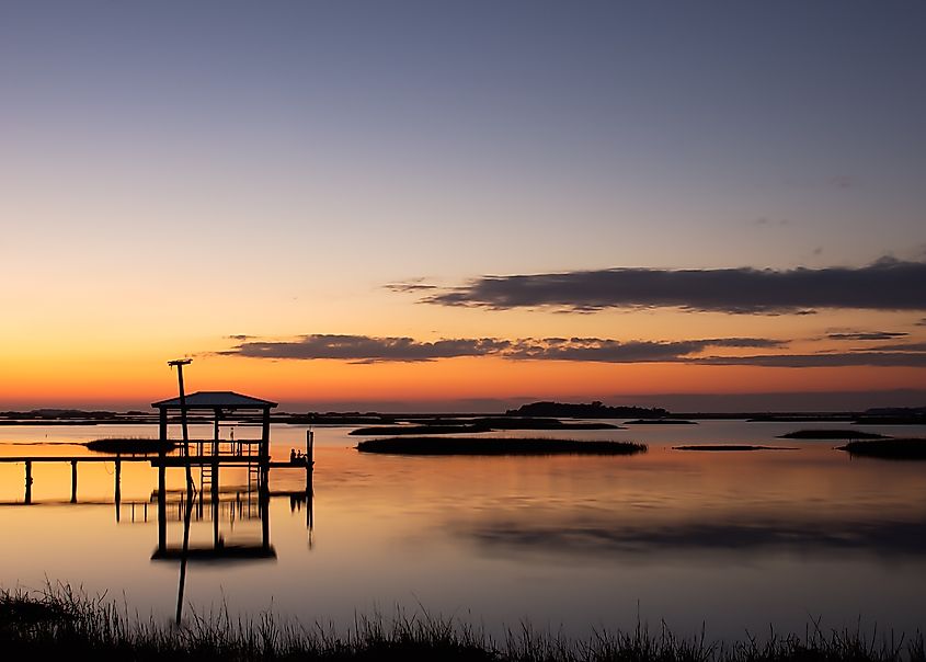 Cedar Key, Florida. Dock with sunset and saw grass.