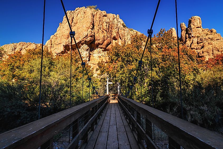 Wooden bridge in Boyce Thompson Arboretum Arizona, USA, magma rock at the backdrop.