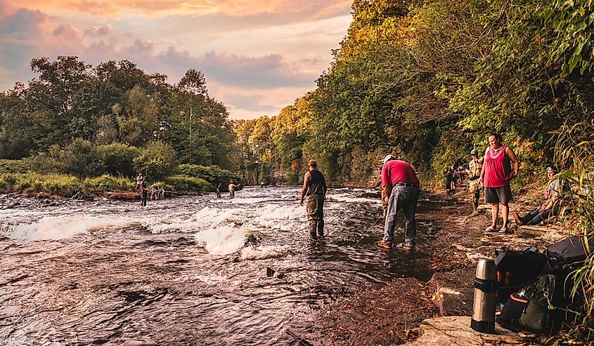 People fishing at Salmon River before sunset at Pulaski, New York.