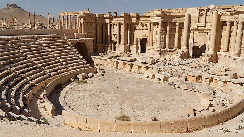 The ancient ruins of Palmyra, Syria, showcasing the remnants of grand colonnades, temples, and stone structures that once stood as a prominent trading hub in the Roman Empire.