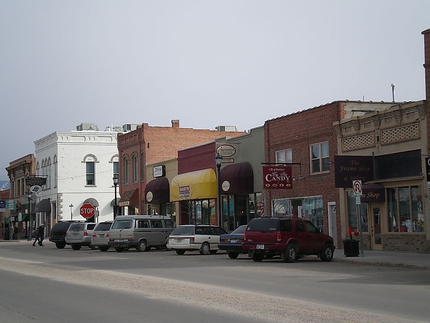 Main Street in Hamilton, Montana, with shops and buildings lining the road in a small-town setting.