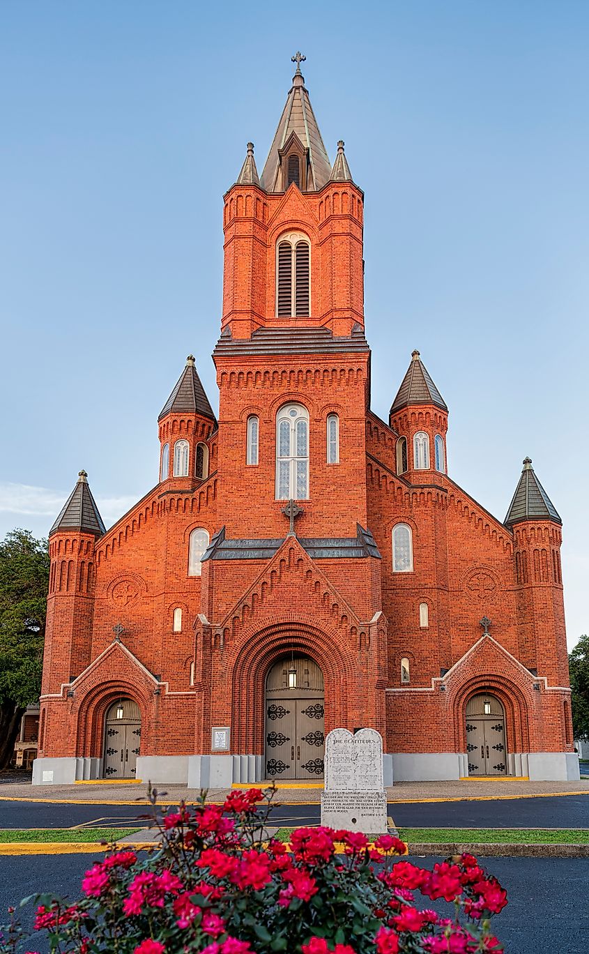 St. Landry Catholic Church With Roses in Foreground in Opelousas, Louisiana.