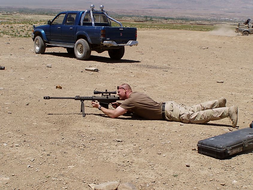 A US Navy EOD Commander fires an M82A1 on a mission in Afghanistan. Image Credit Tomhubbard via Wikimedia Commons.