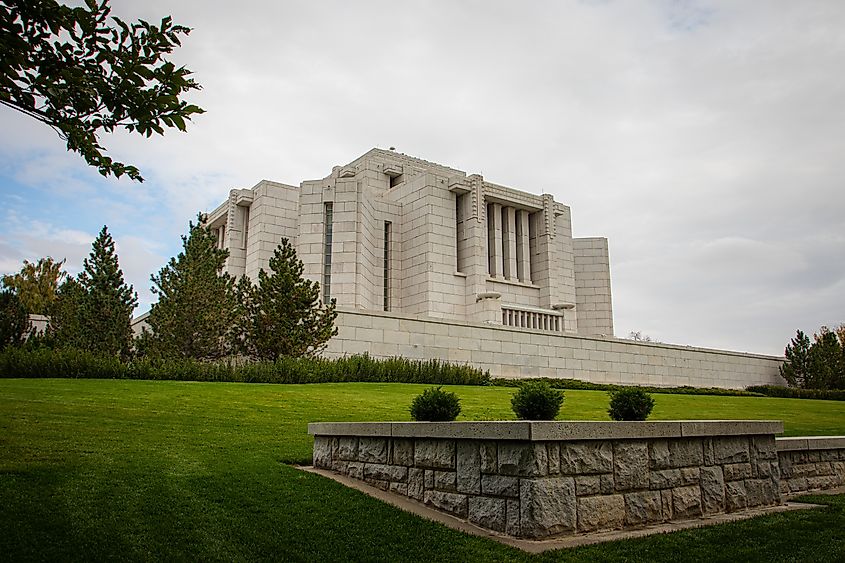 The Cardston Alberta Temple surrounded by vibrant fall foliage.