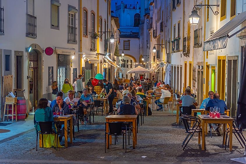 People dine on a street in Évora, Portugal.