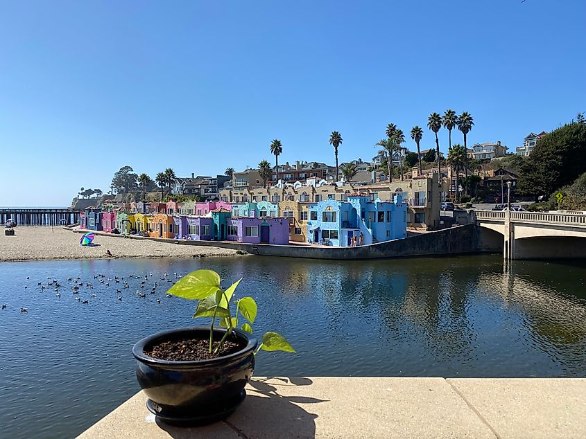 A patio view of rows of brightly painted houses comprising California's Capitola Village. 