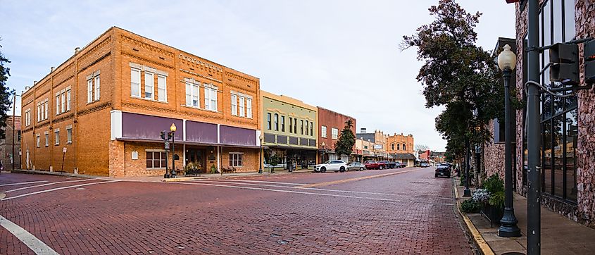 View of downtown Nacogdoches, brick covered streets and old historic buildings.