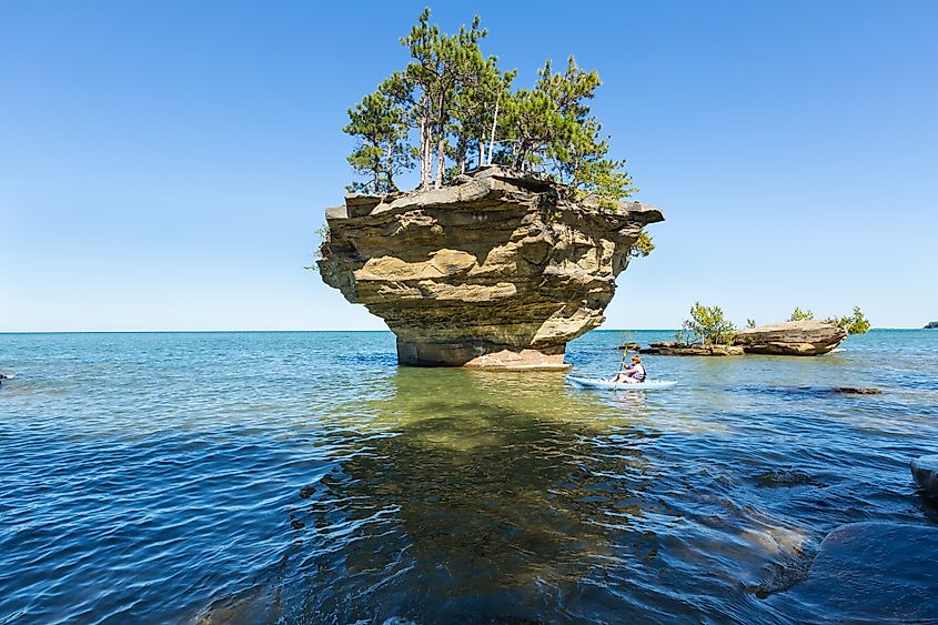 A kayaker passes Turnip Rock in Lake Huron near Port Austin, Michigan.