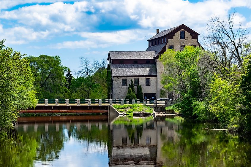 A brown stone mill and bridge over the Milwaukee River in Cedarburg, Wisconsin. 