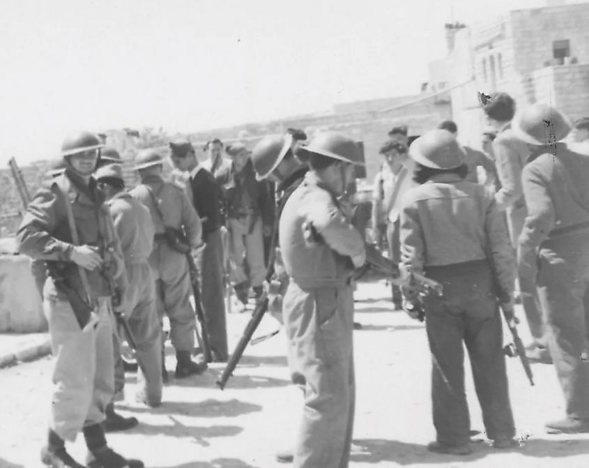 Fighters from Israel's pre-state militia occupying the village of Deir Yassin, April 1948. Source: Wikimedia/IDF Archive.