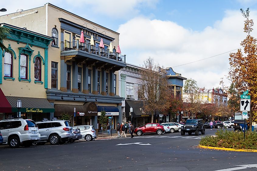 Ashland, Oregon: People walking to the shops with vehicles parked on the streets.
