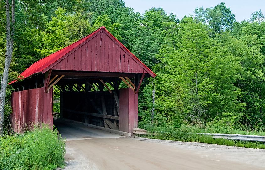 The Red Covered Bridge crosses the Sterling Brook in a wooded section of Morristown, Vermont. Editorial credit: Kevin M. Walsh / Shutterstock.com