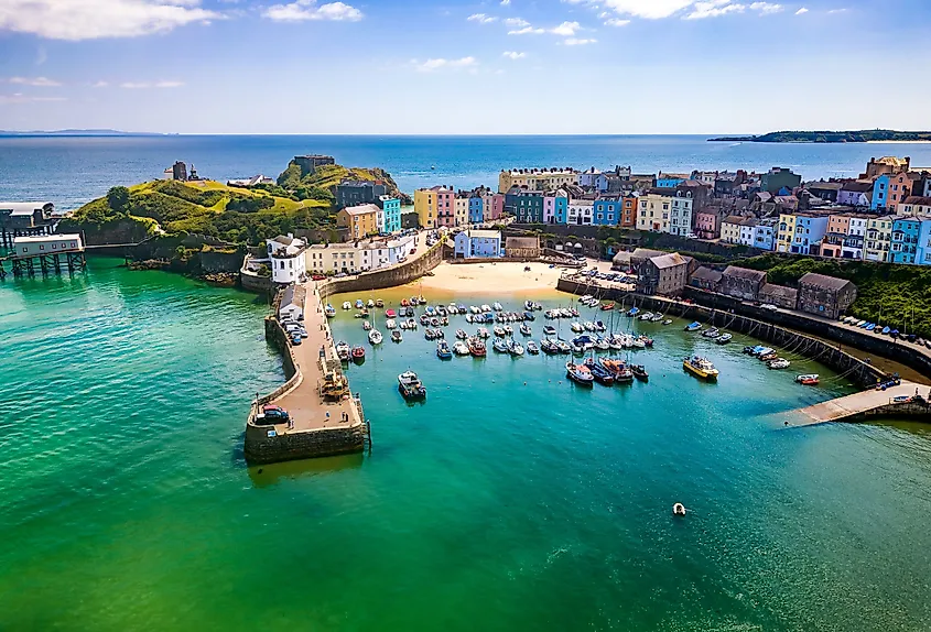 Aerial view of colorful buildings around a small harbor in Tenby, Wales.