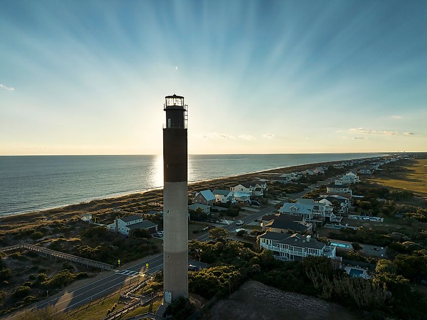Sunset behind the Oak Island lighthouse on Oak Island, North Carolina.