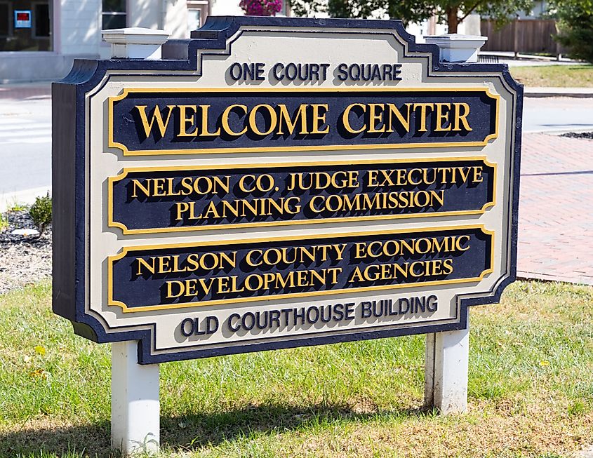 A welcome center sign in front of the Bardstown, Kentucky courthouse at One Court Square.
