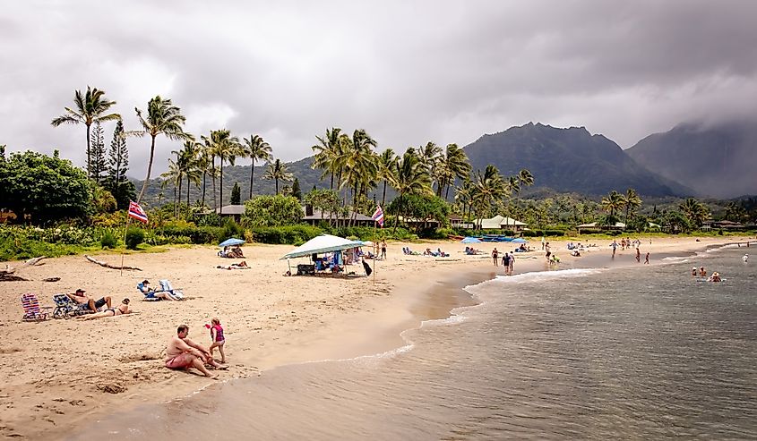 People along Hanalei Bay Beach in Hanalei, Hawaii.