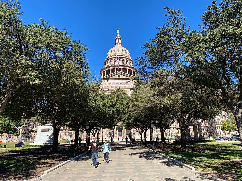 The tree-lined lead up to the south entrance of the stately Texas Capitol building. 