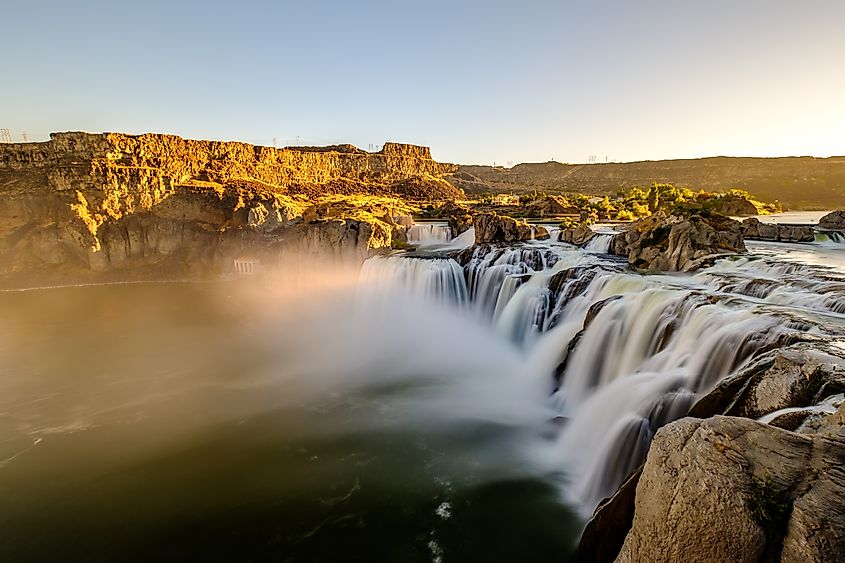 Shoshone Falls at sunrise in Twin Falls, Idaho, USA, with cascading water illuminated by the early morning light