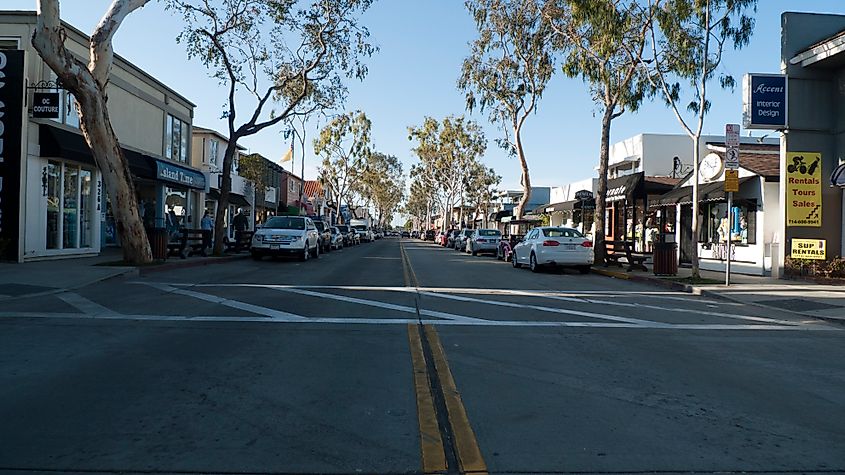 Main Street on Balboa Island, featuring charming shops and storefronts along a bustling street in a coastal community.