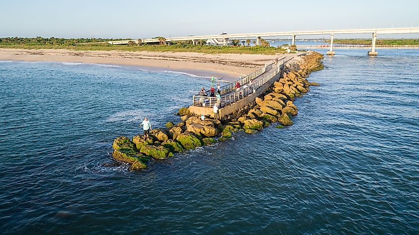 Drone view of the pier at Sebastian Inlet during sunrise