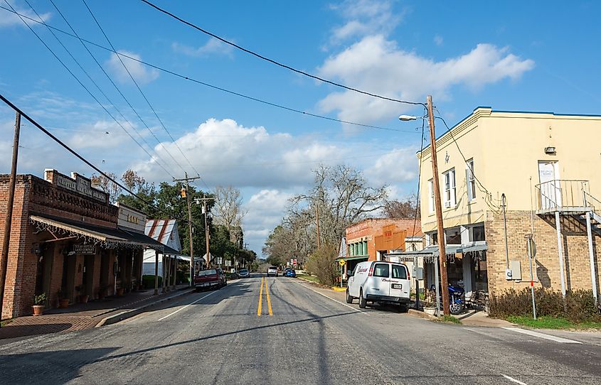 Main street in Chappell Hill, Texas, with buildings and cars.