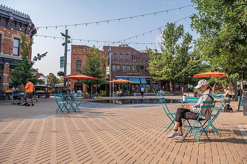 People hang out in the famous Old Town Square of Fort Collins, Colorado, via Page Light Studios / Shutterstock.com
