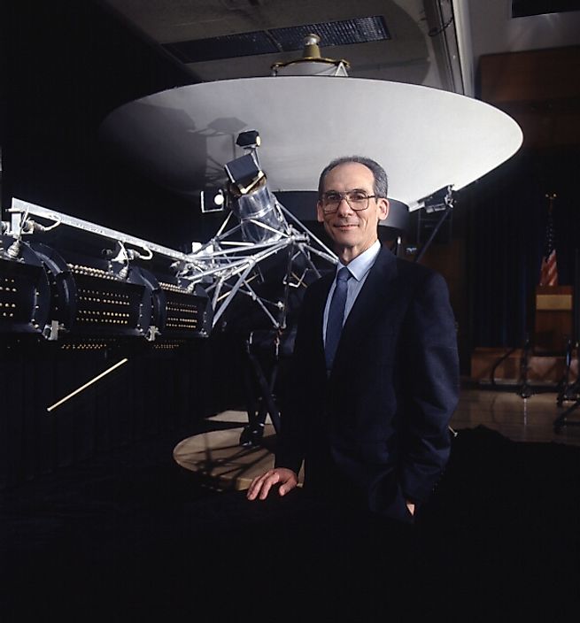 Edward C. Stone, director of NASA JPL, standing in front of a Voyager spacecraft model