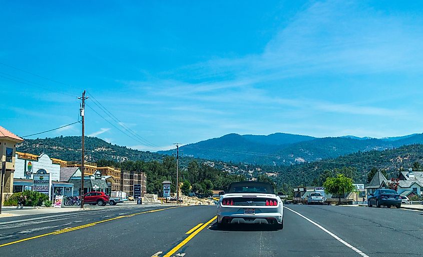 Oakhurst town in California and cars on the highway. Road to the Yosemite National Park