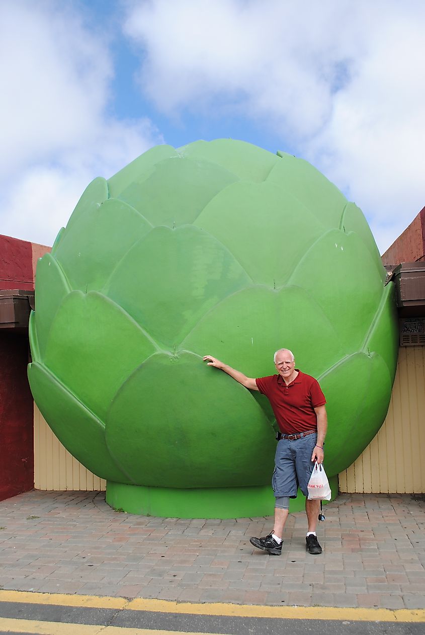 A Tourist Poses in Front of the Giant Artichoke Statue in Castroville. Editorial credit: Lisa T Snow / Shutterstock.com