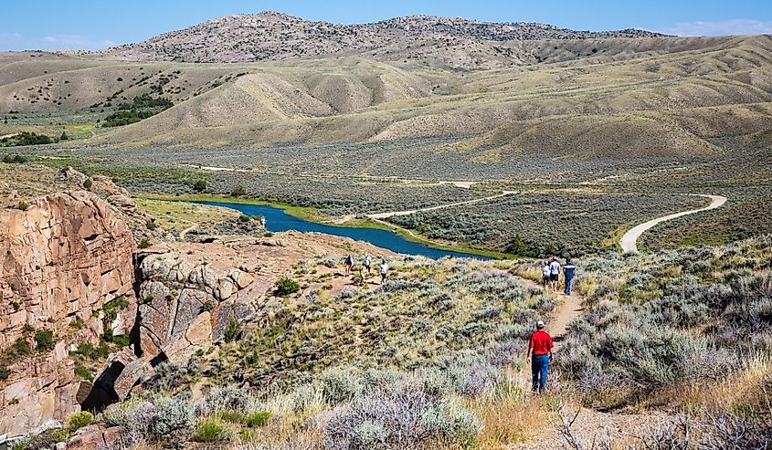 People hiking on a trail along the north platte river just downstream from Pathfinder dam, near Alcova, Wyoming.