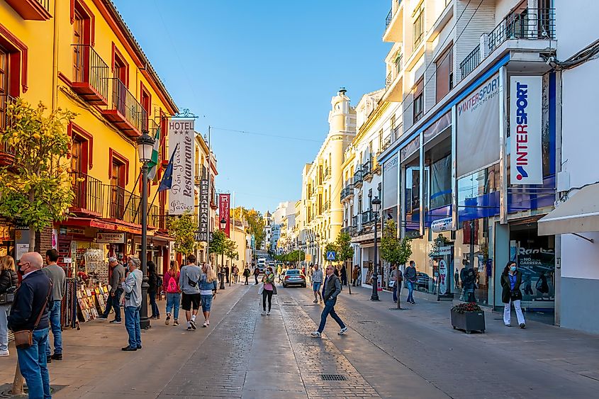 People walking along downtown Ronda in Spain.
