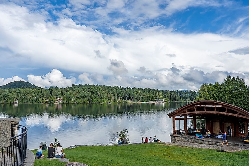 People enjoying a good time with loved ones along Mirror Lake in Lake Placid, New York